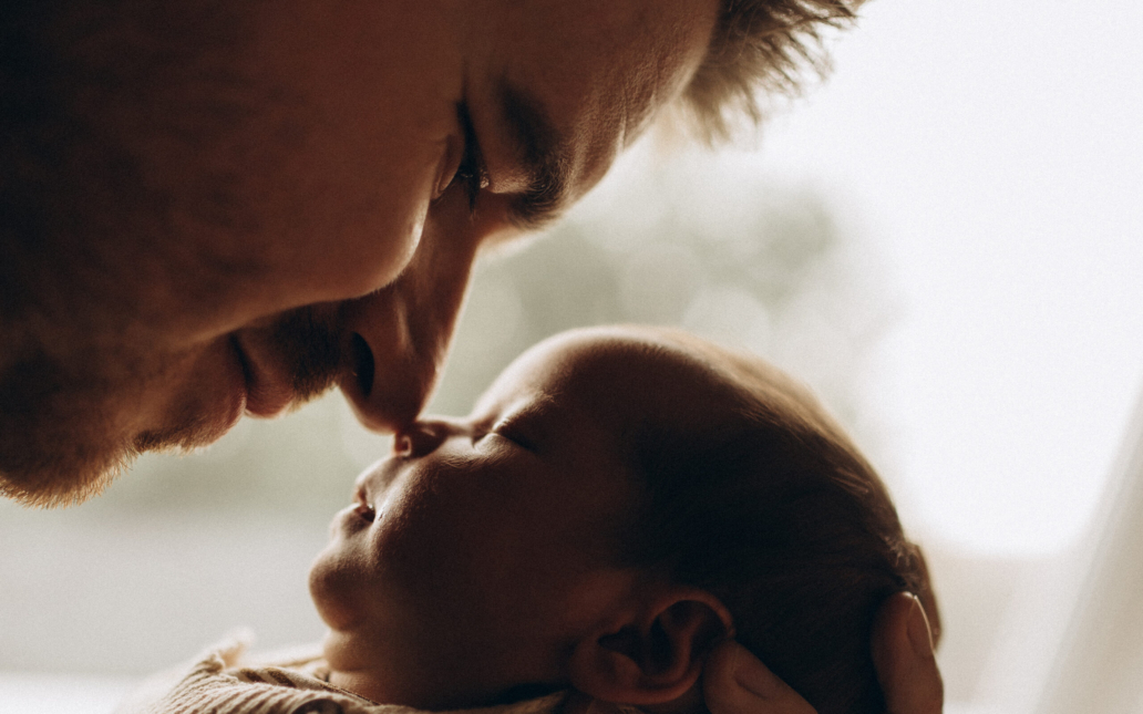 father holing baby in a close-up natural light session in amsterdam
