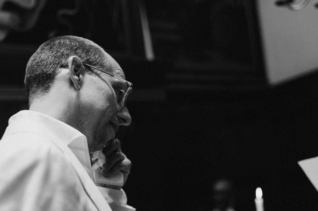 a groom wiping his tears during the wedding vows